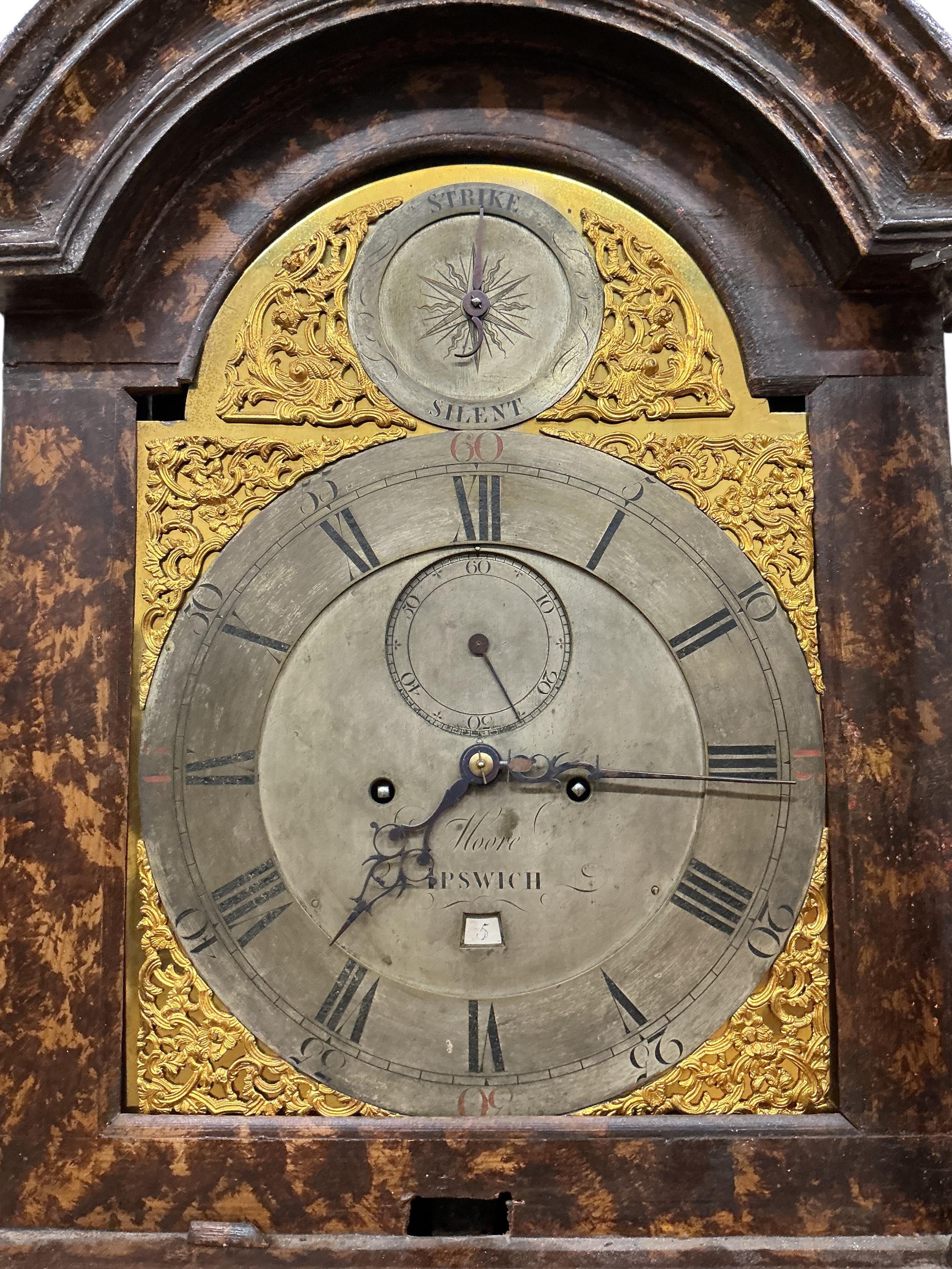 A George III simulated mulberry eight day longcase clock, the arched brass dial with strike silent and subsidiary seconds dial, date aperture, signed Moore, Ipswich, height 240cm